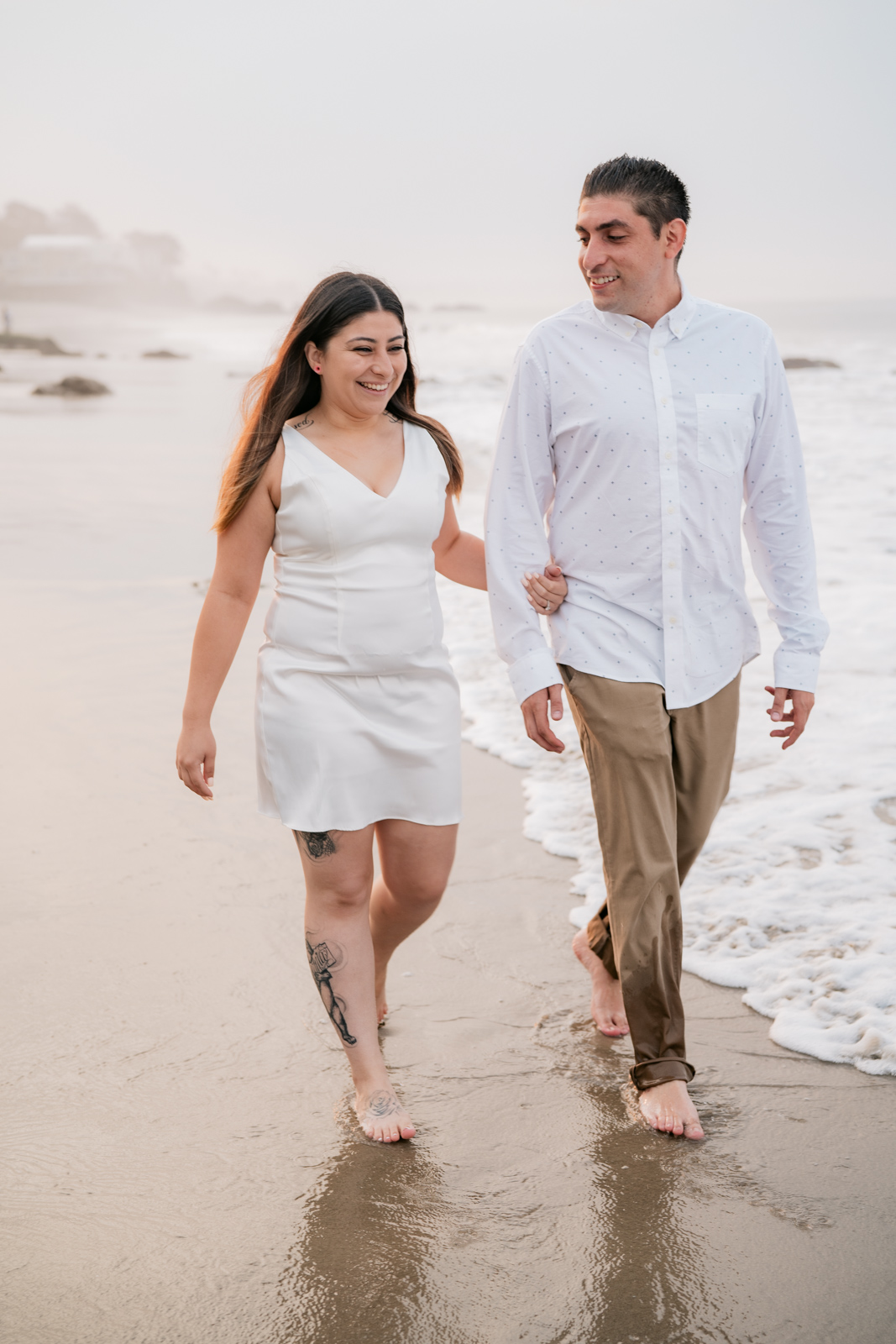 Couple walking on beach holding hands