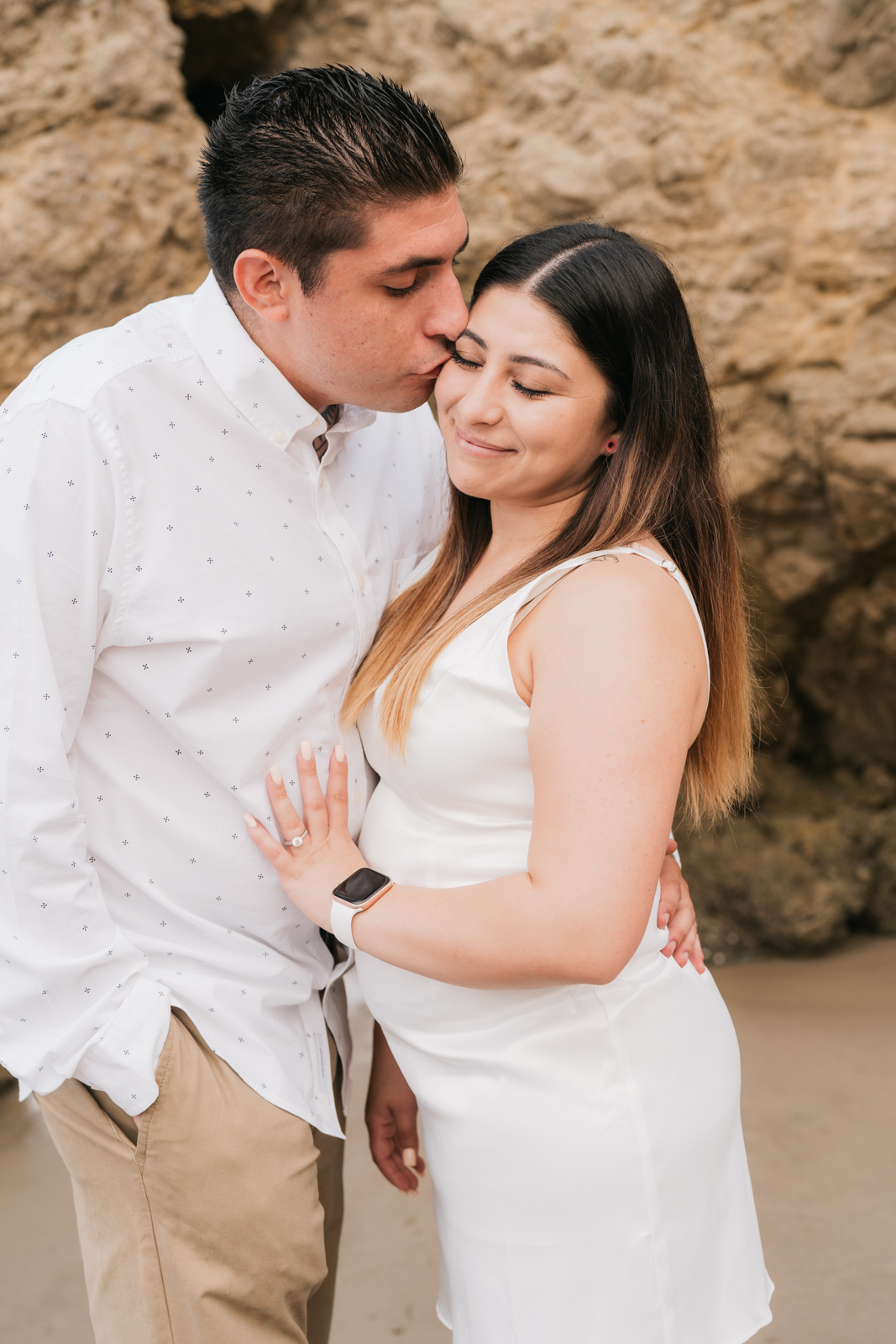 Man kissing fiance on cheek